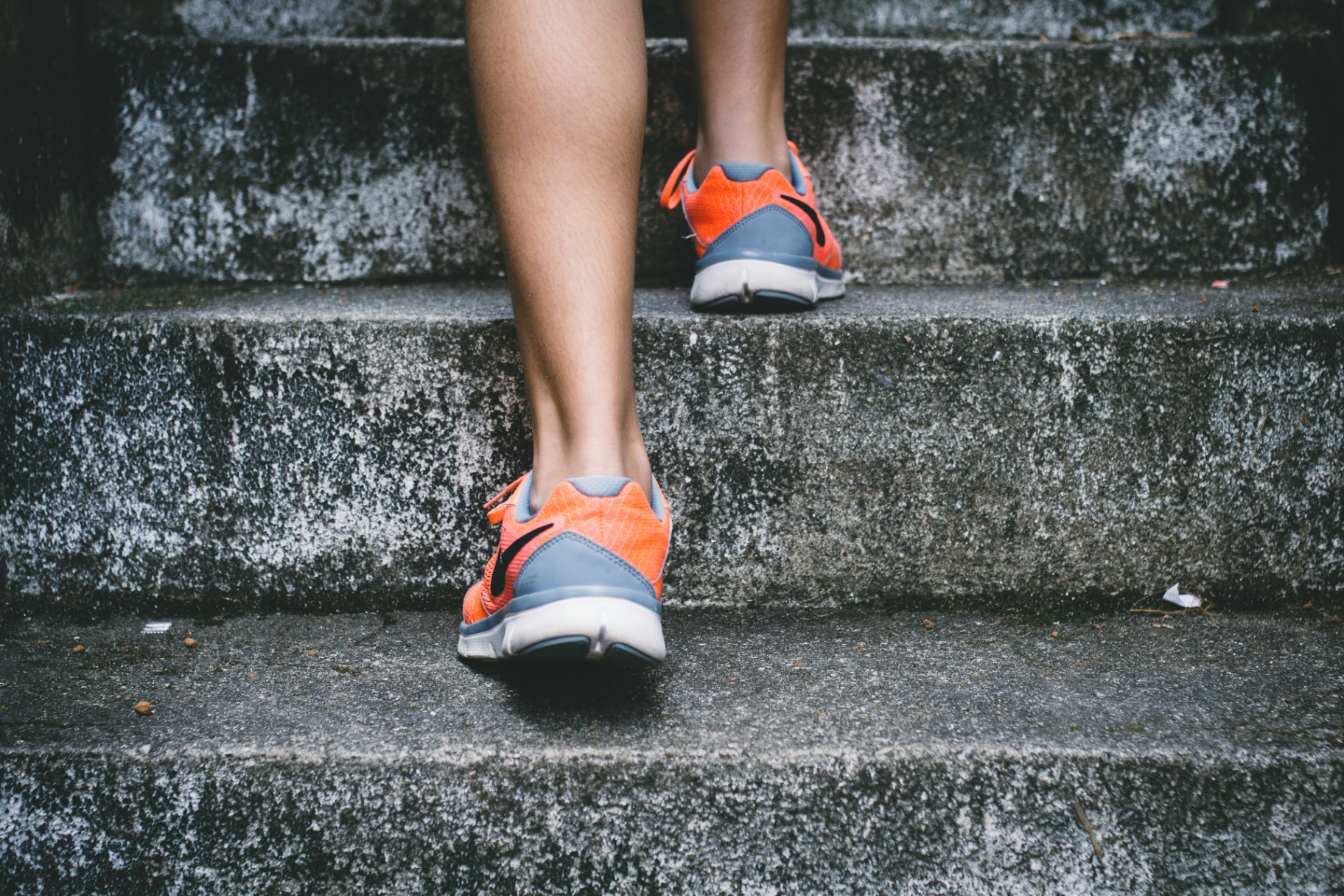 A runner taking the steps in orange trainers